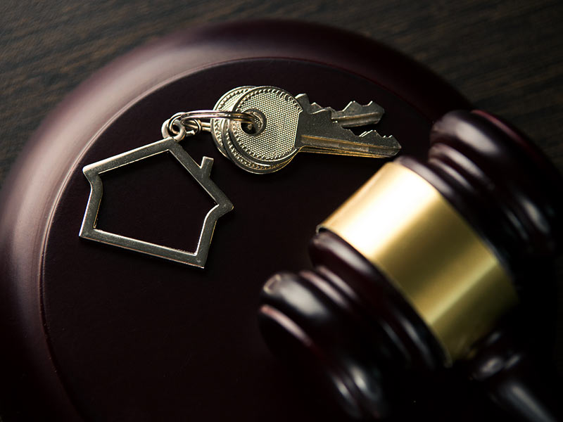 a lawyers mallet next to a houses keys chicago il